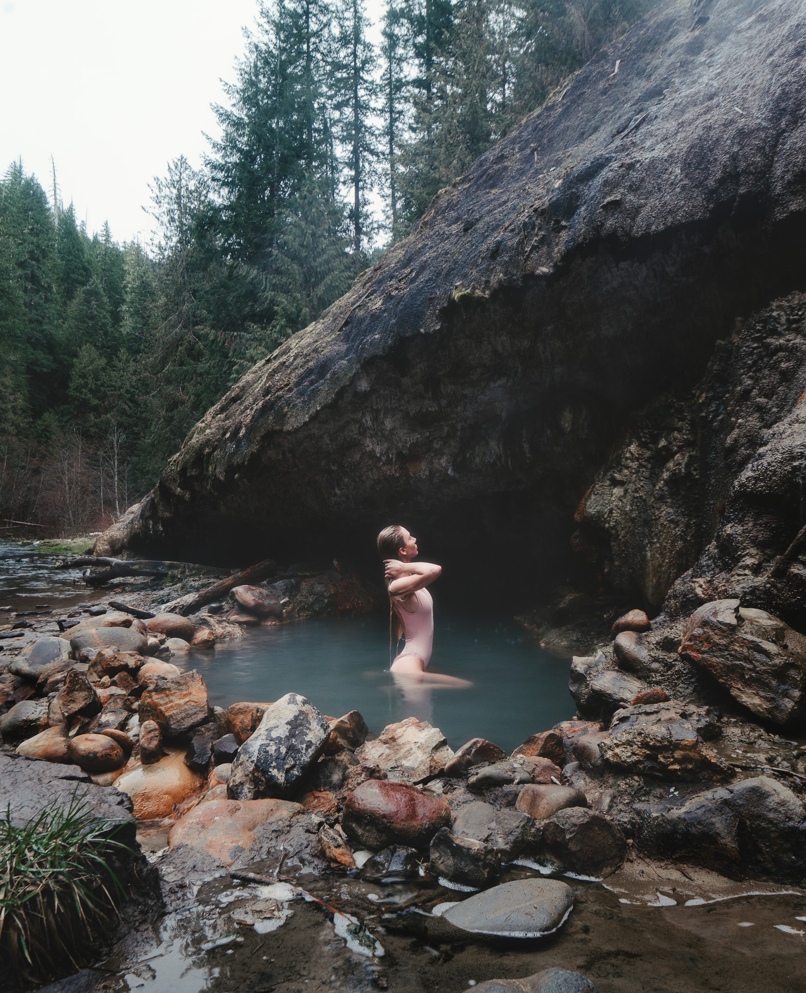 Girl in a hot spring river in Oregon